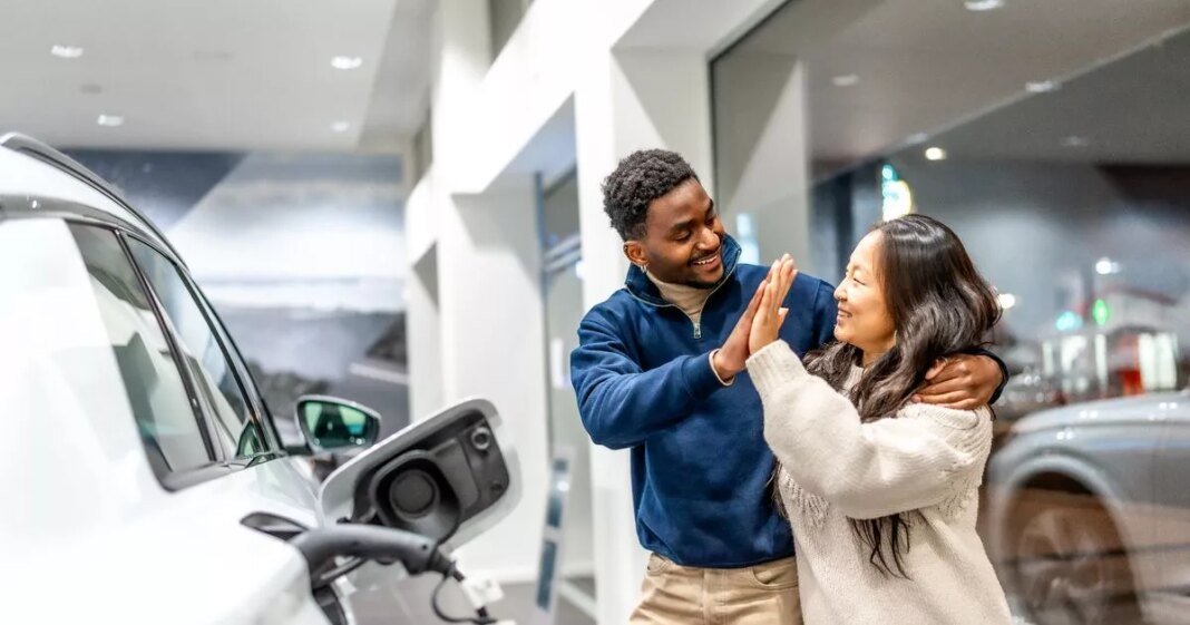 1_prod-happy-multiethnic-couple-celebrating-buying-electric-car-at-dealership