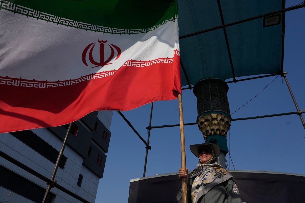 default-519 A woman holding an Iranian flag in Tehran.